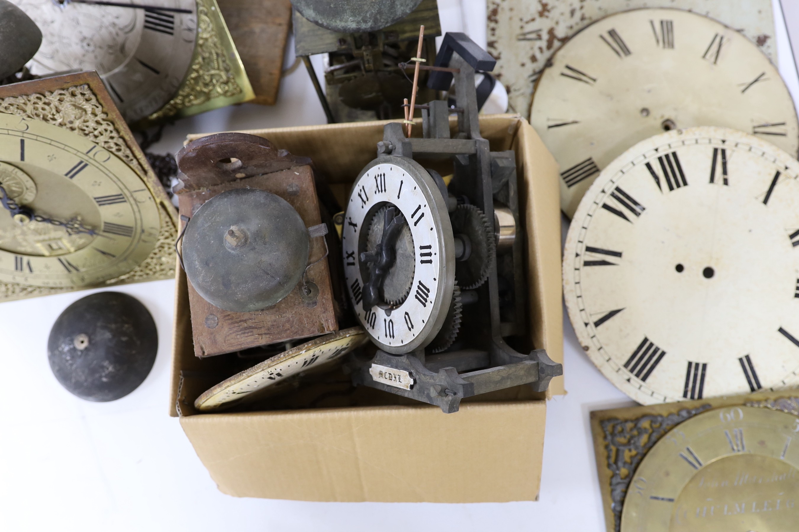 A large quantity of clock parts, to include movements, dials etc., including a John Marshall of Chulmleigh clock face